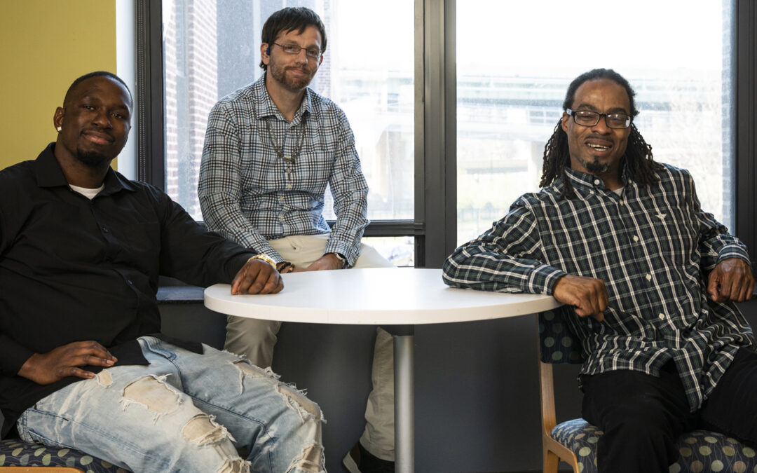 3 young men in treatment sitting at a table