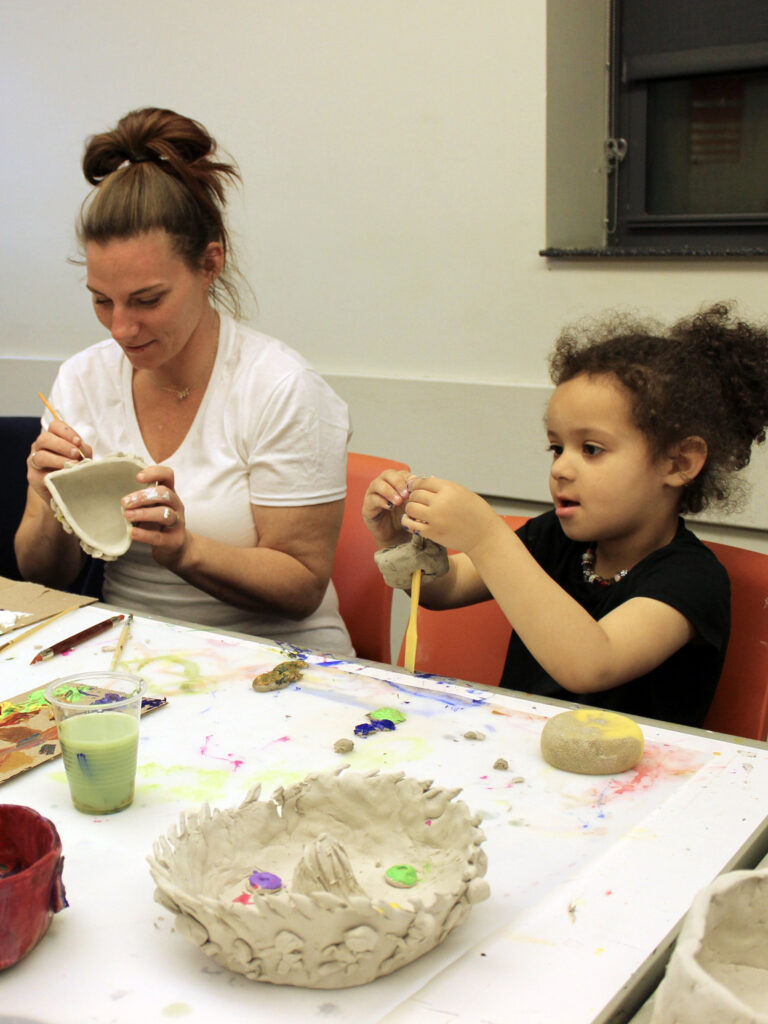 Mother and daughter playing with clay